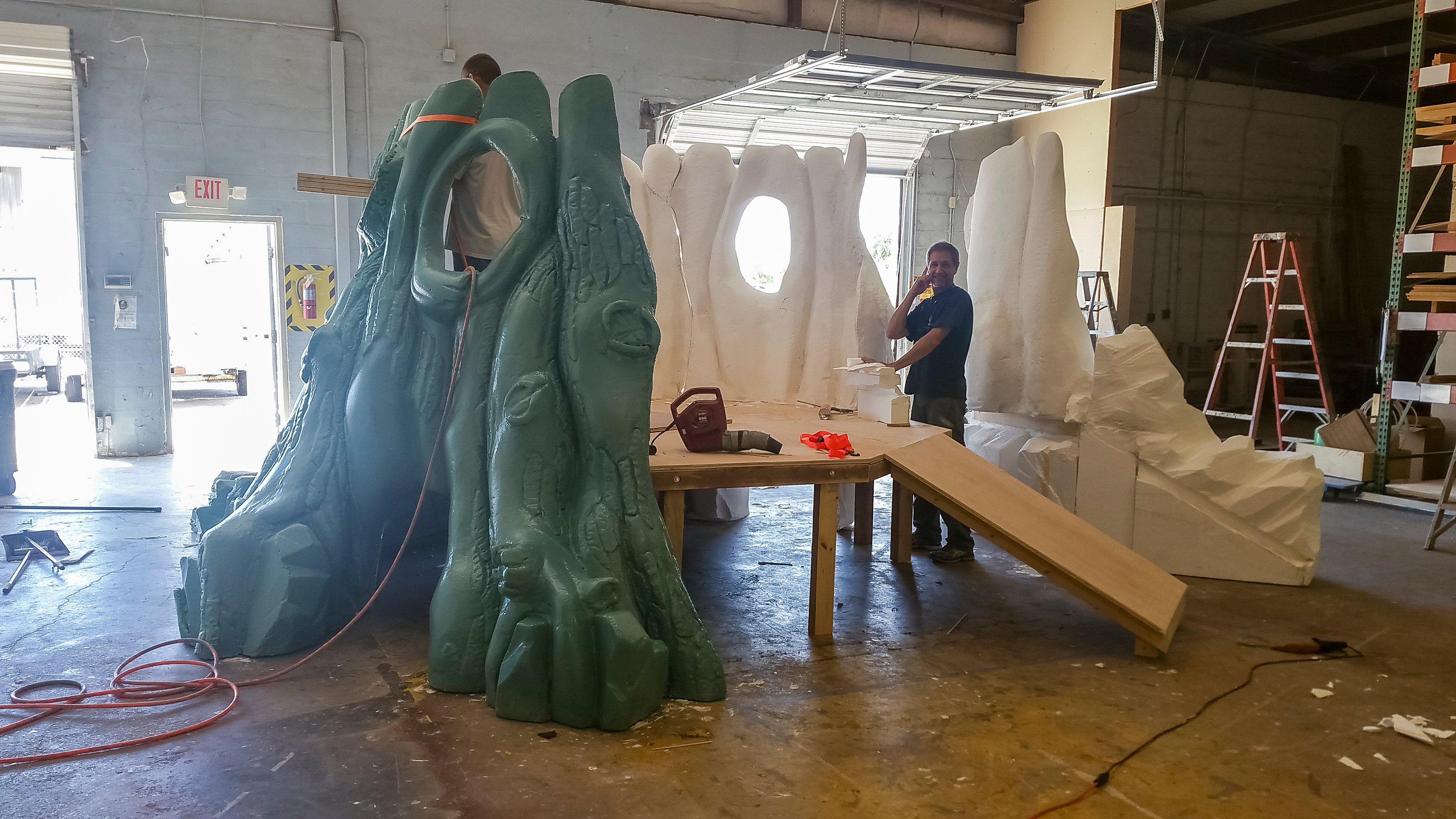 Custom sculpted tree play feature under construction for Faith Community Church's camp-themed children's ministry at the Wacky World Studios fabrication shop.