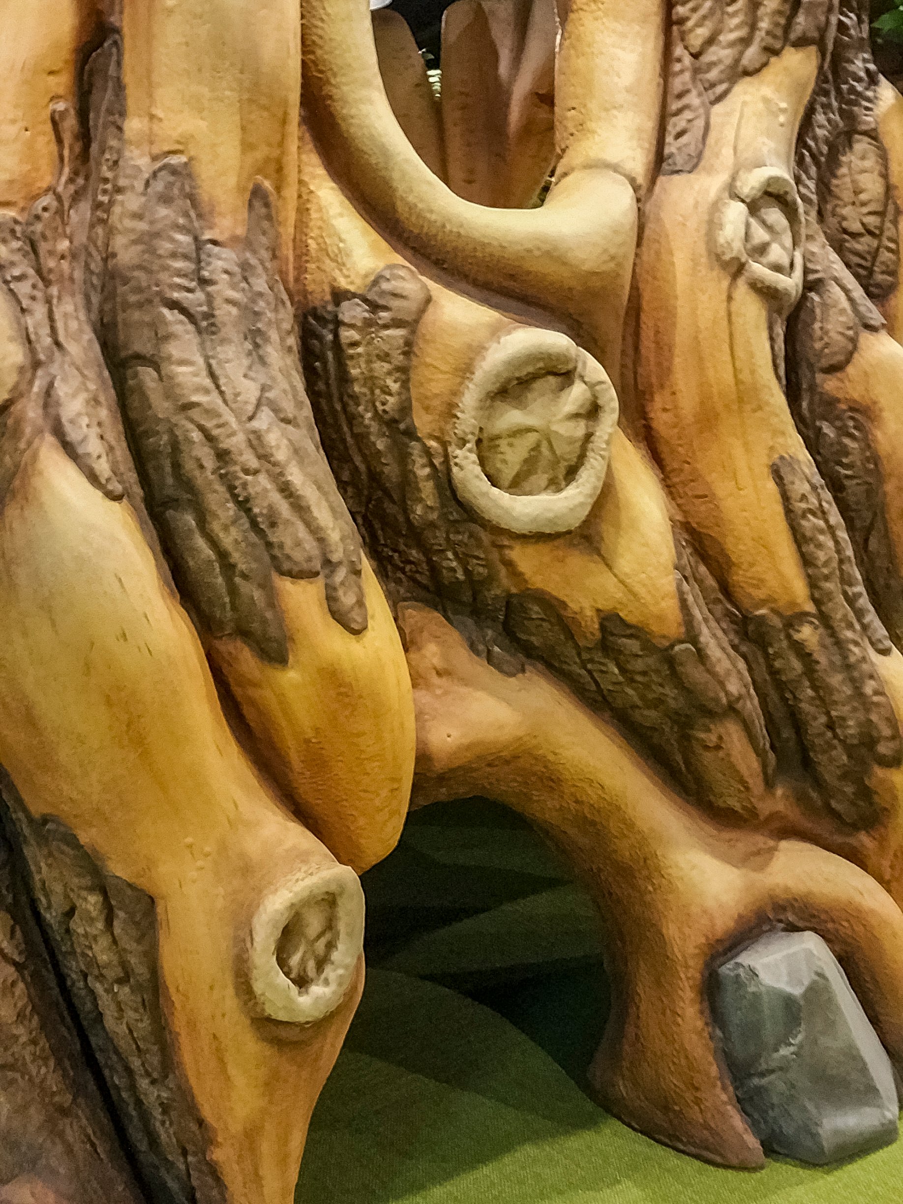 Close-up of realistic wood grain, bark textures, and carved details on a custom sculpted tree in Faith Community Church's camp-themed children's ministry.