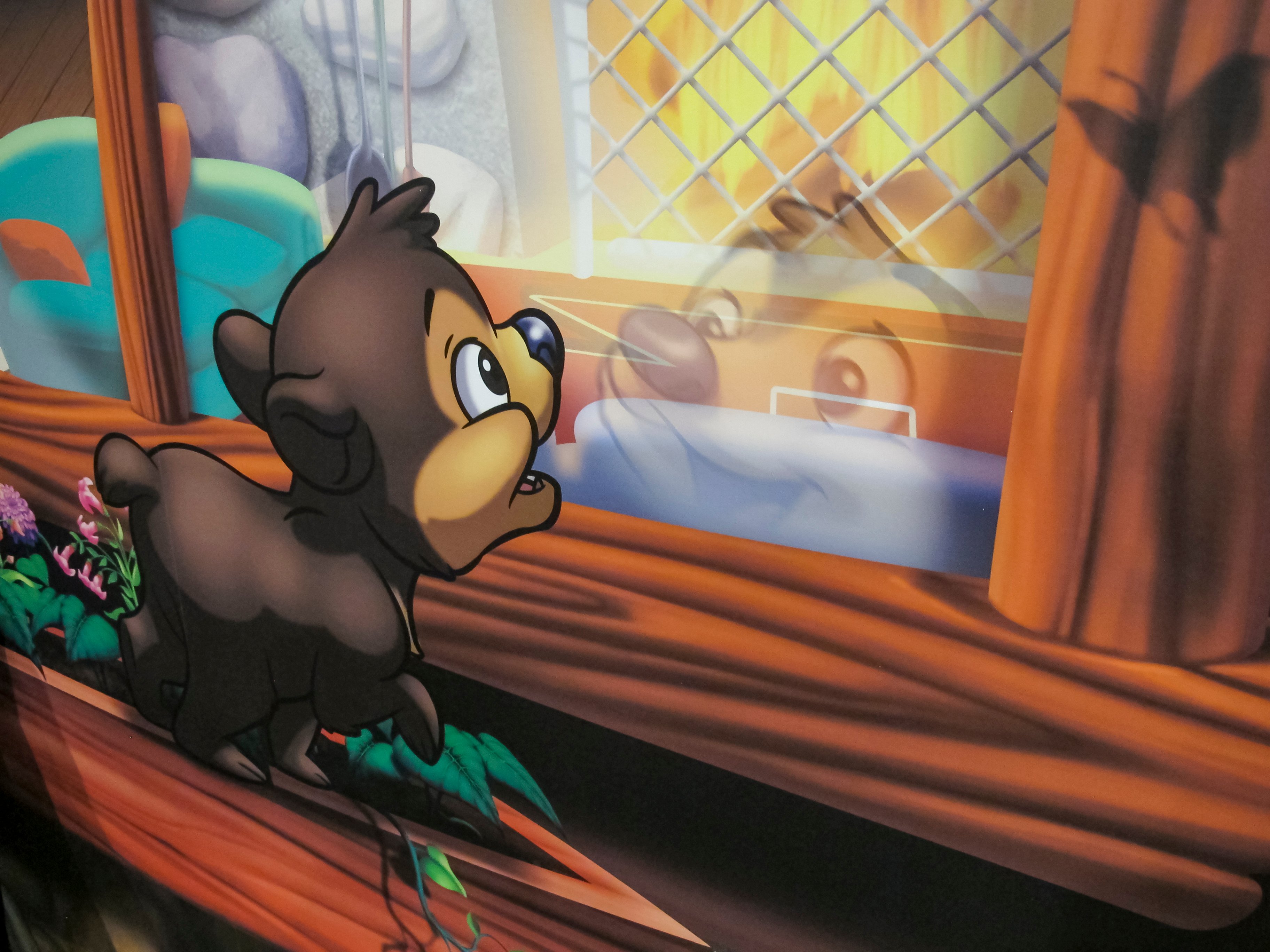 Close-up of a custom illustrated bear character reflected in a lodge window, showcasing the detailed artwork in Faith Community Church's camp-themed children's ministry murals.