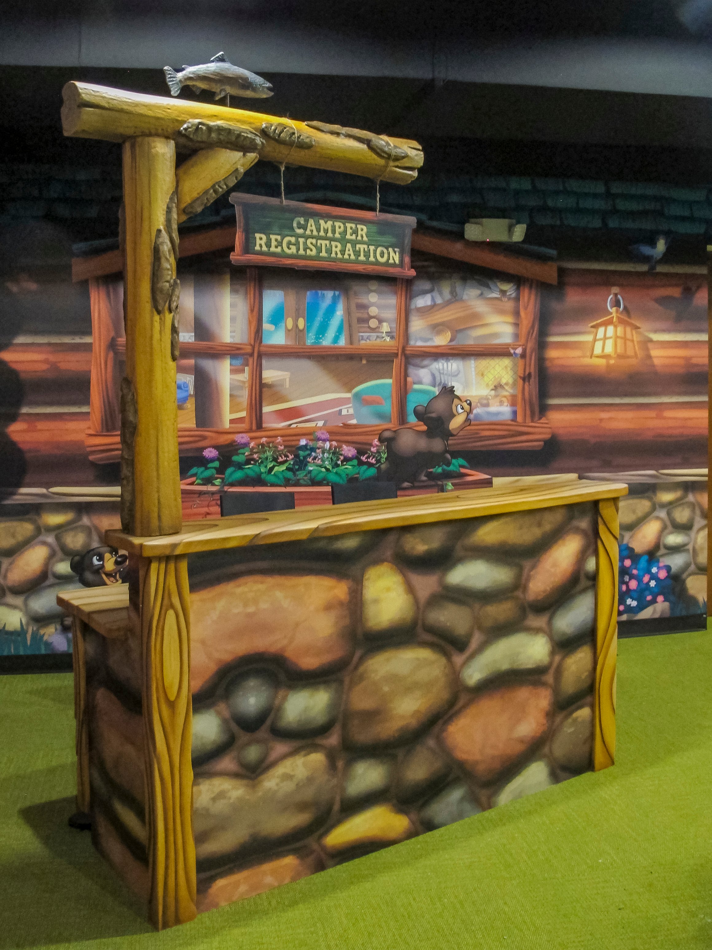 Custom Camper Registration station with rustic camp-themed graphics in Faith Community Church's FaithKids children's ministry.