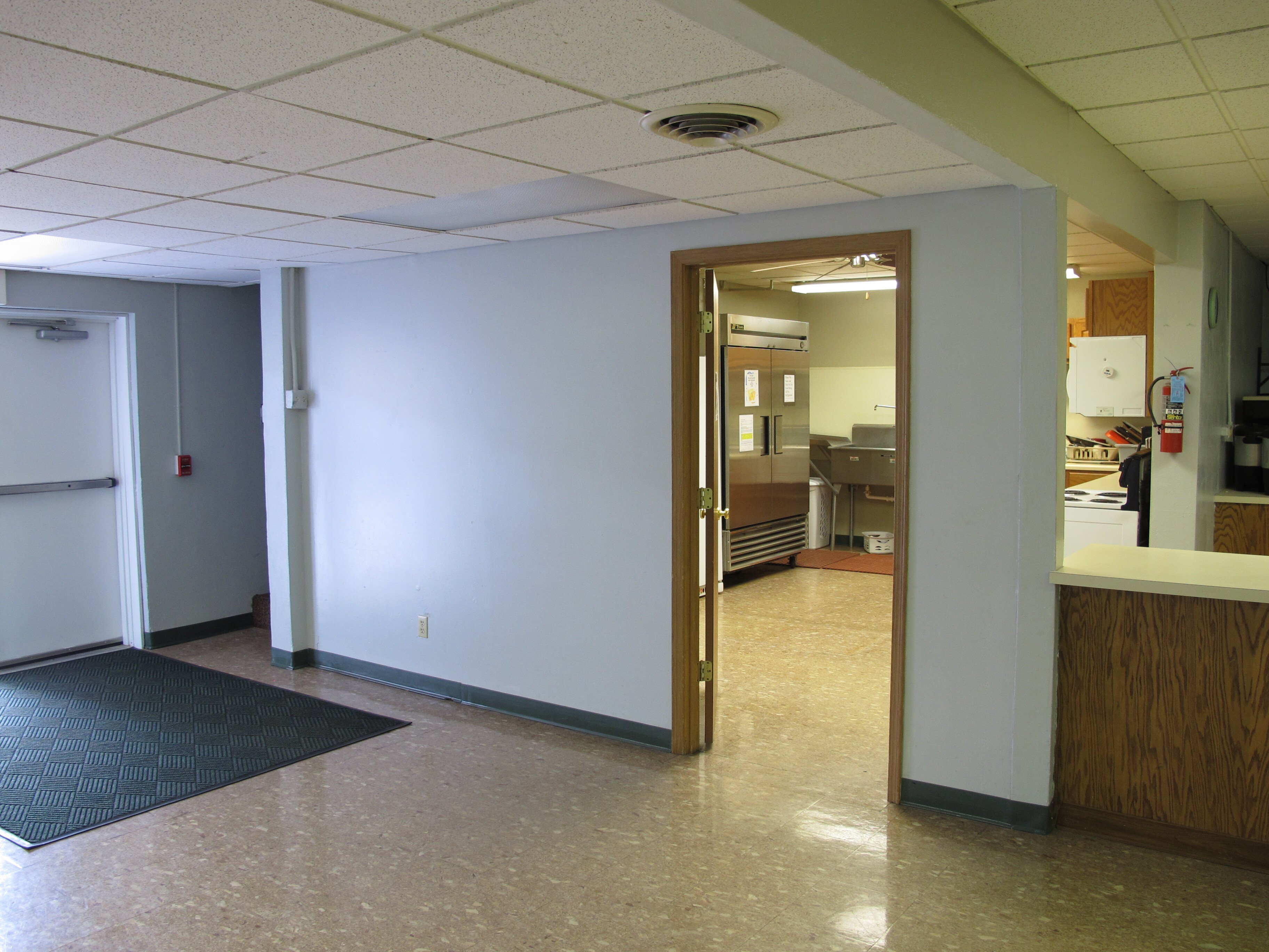 Before photo of Faith Community Church's children's ministry showing the existing space prior to its camp-themed transformation.