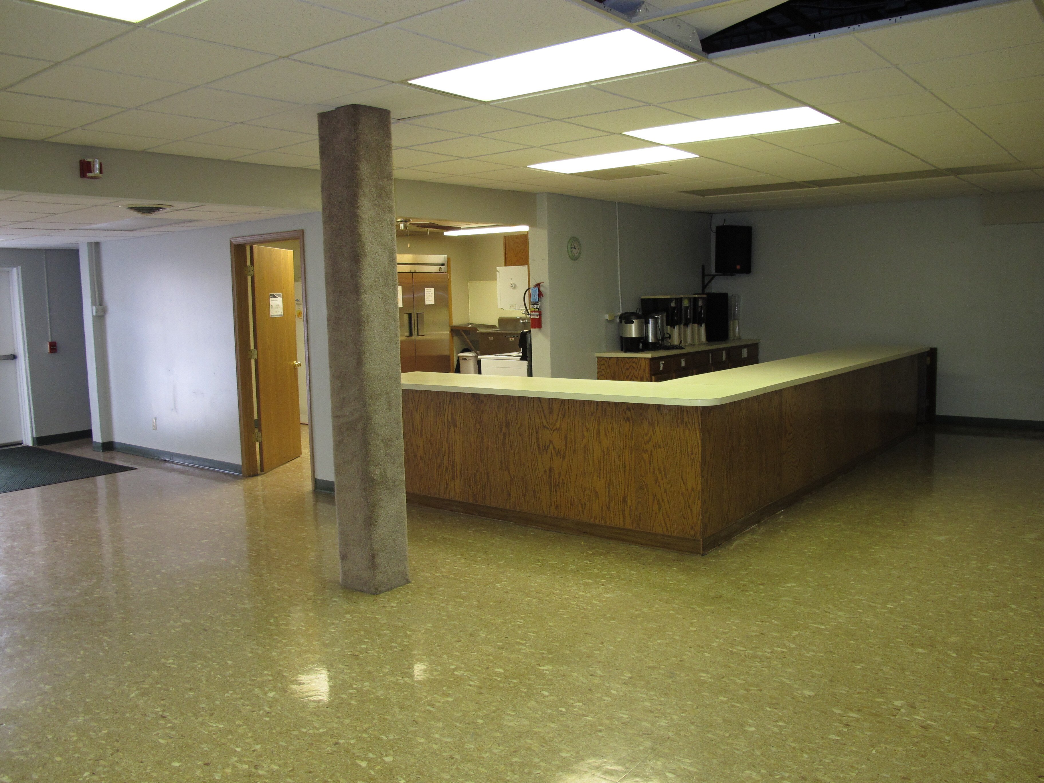 Existing children's ministry lobby before custom murals, themed graphics, and a sculpted tree check-in station transformed the space at Faith Community Church.