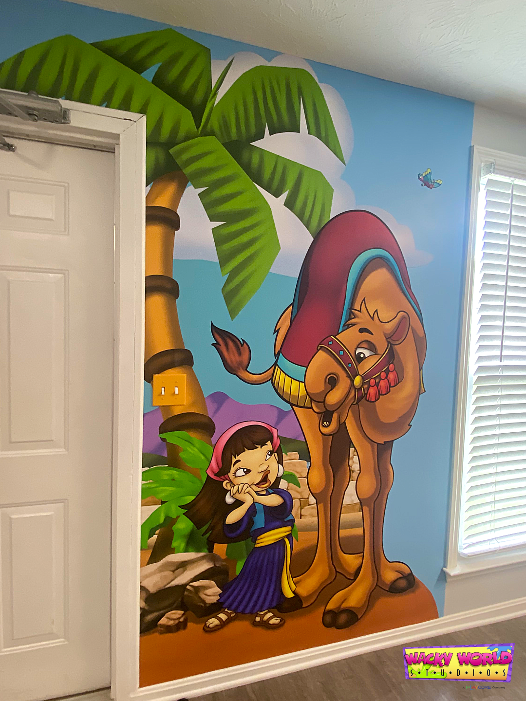 Camel and marketplace mural inspired by biblical culture in a church children's ministry hallway