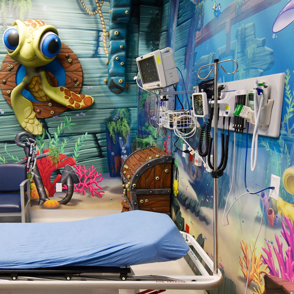 3D relief sculpted Turtle in a porthole plus sunken ship murals in an Undersea Themed Space at America's ER