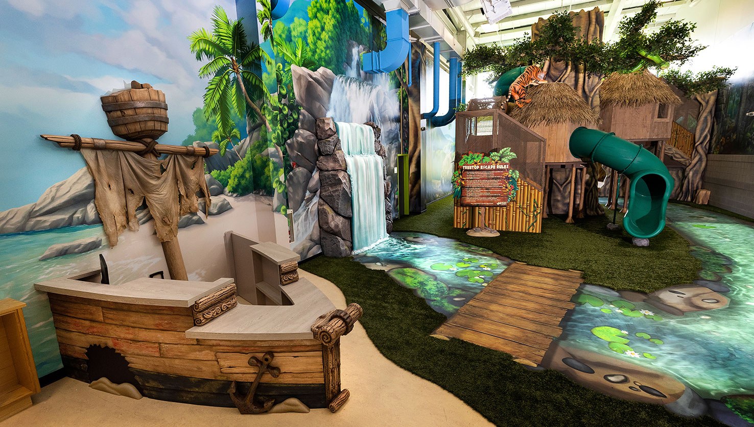 Image features shipwreck check-in desk, waterfall and treehouse with slides at West Chicago Parks District ARC Center
