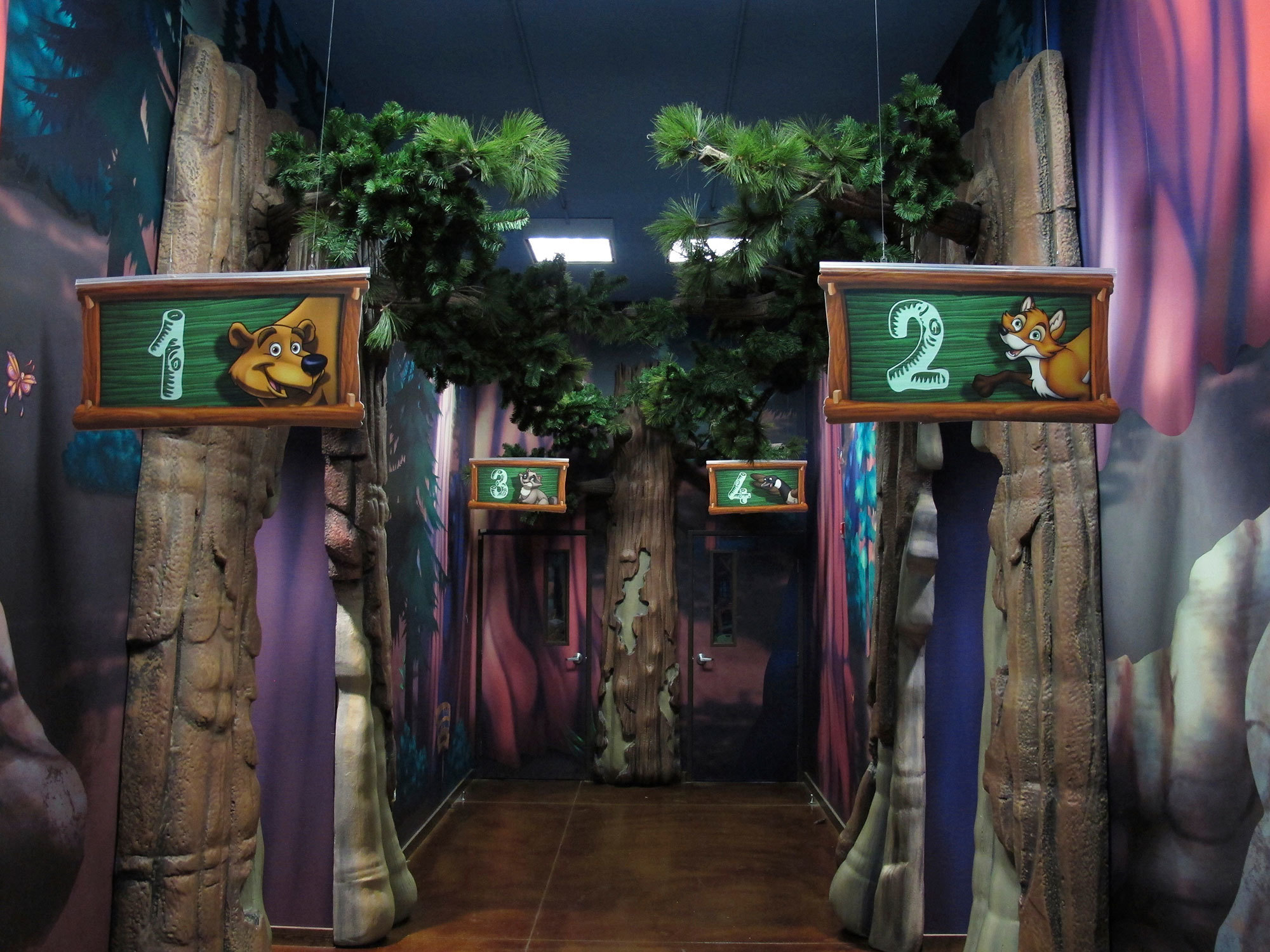 Fully Immersive Camping Themed Environment featuring Forest scene wall murals and 2D classroom signs at Canyon Hills Church