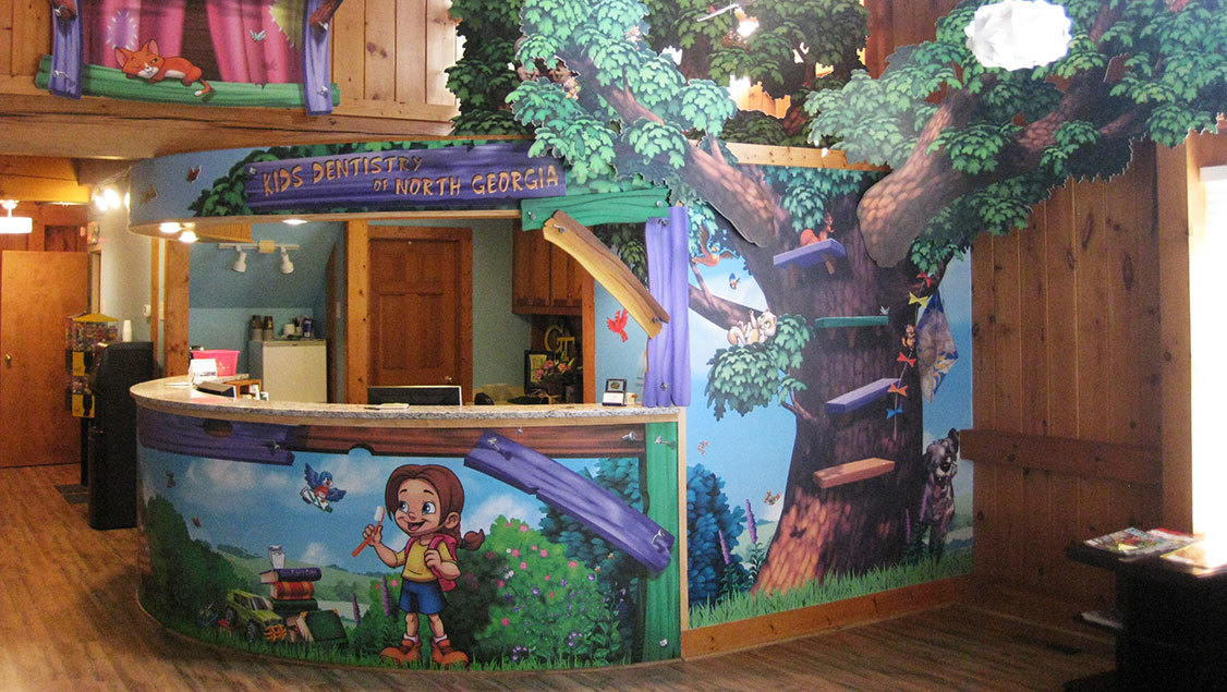 Desk wrap and 2D tree cutout in a Neighborhood Treehouse Themed pediatric facility