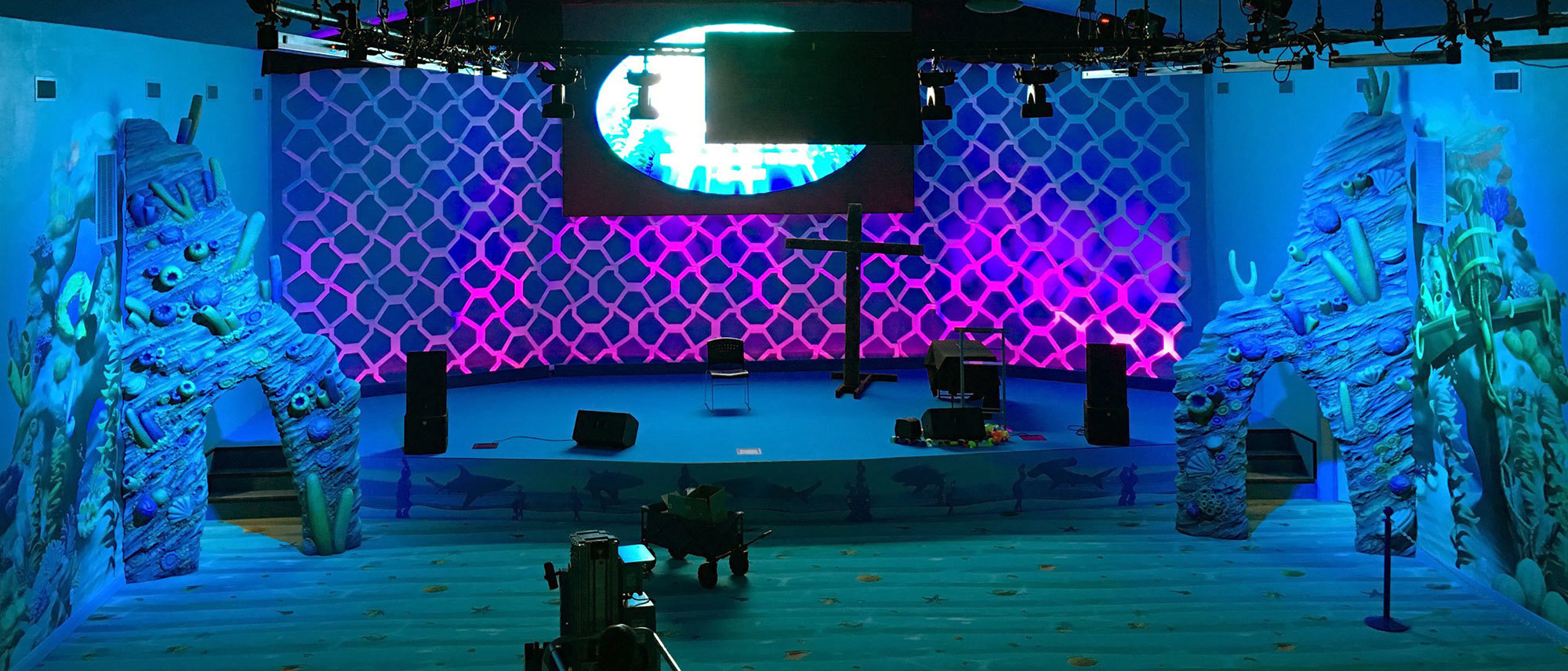 Undersea Themed Stage with 3D sculpted coral reef sides at Trinity Church International