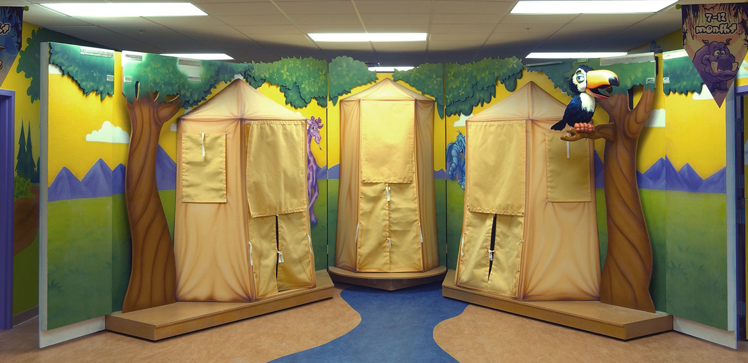 Jungle Themed Puppet Stage with a green, blue and yellow mural with 2D trees, a 3D sculpted Toucan and three yellow tents.