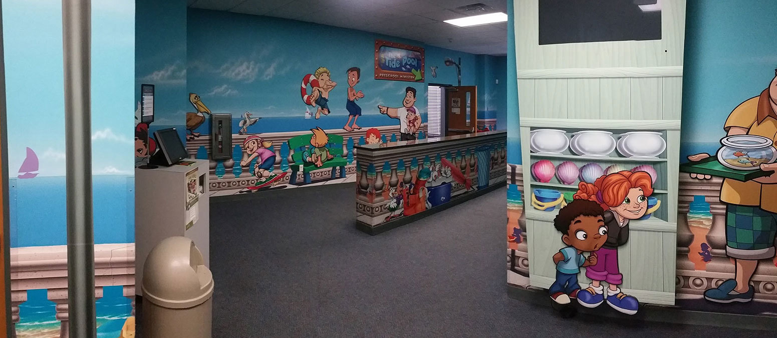 Beach and Boardwalk Themed Wall Covering with kids playing, an adult pointing, coolers, birds and other animals.