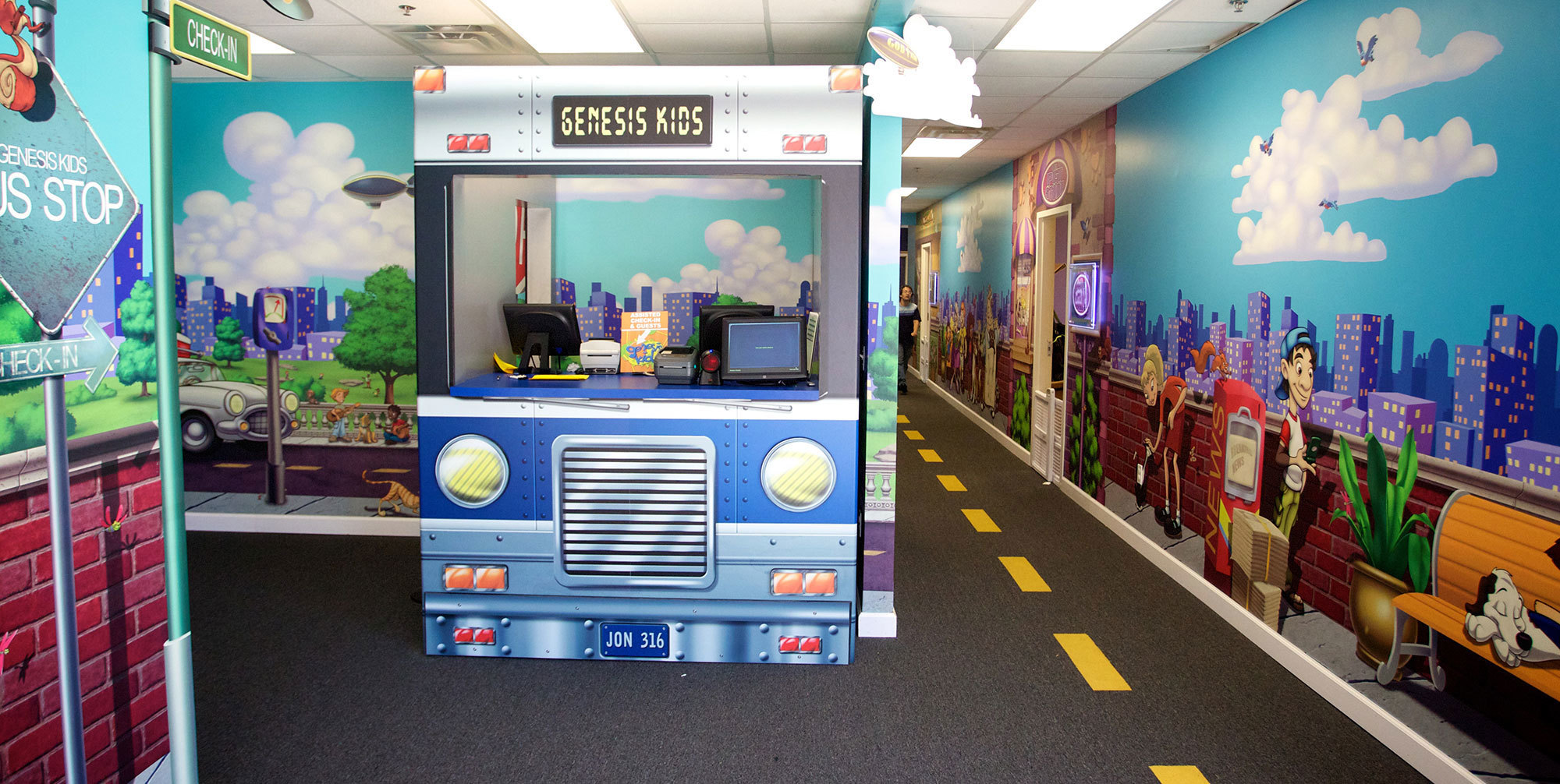 Big City Toon Town Themed Wall Covering plus  2D cutout bus as a check in desk.