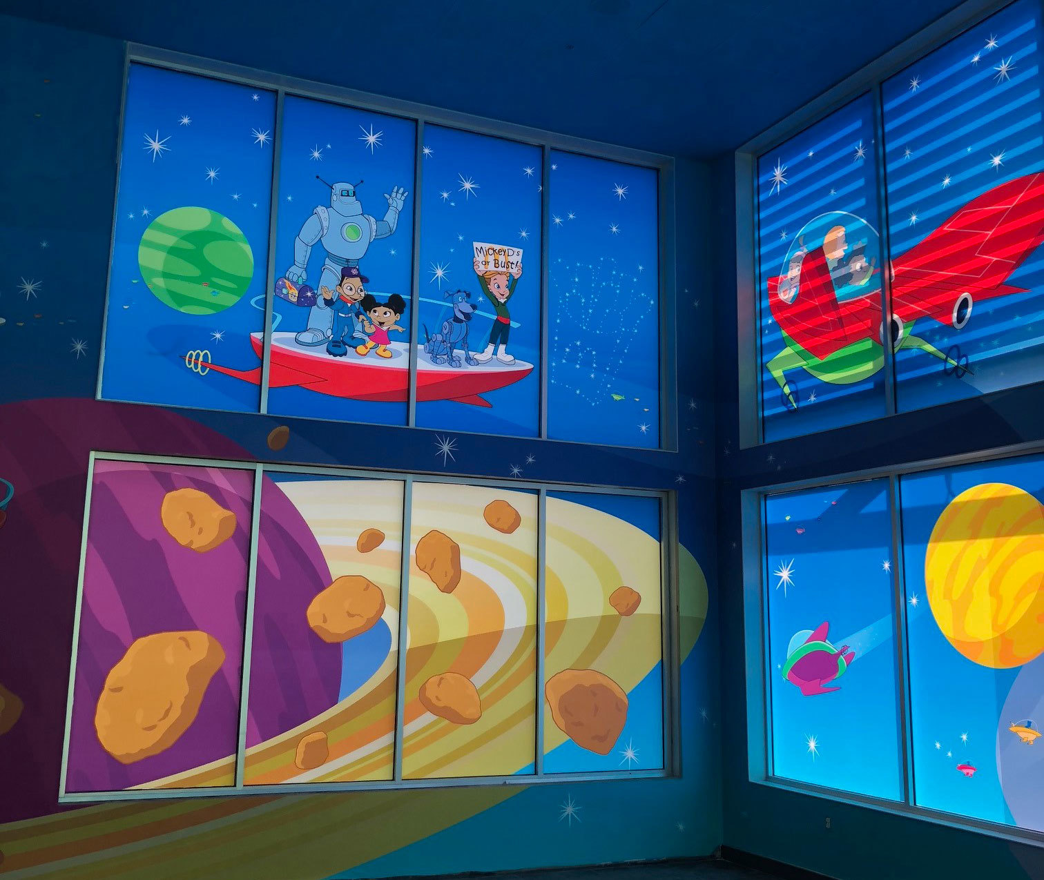Space Themed Window Vinyl depicting planets and a space family traveling in a flying car at McDonald's in Florida