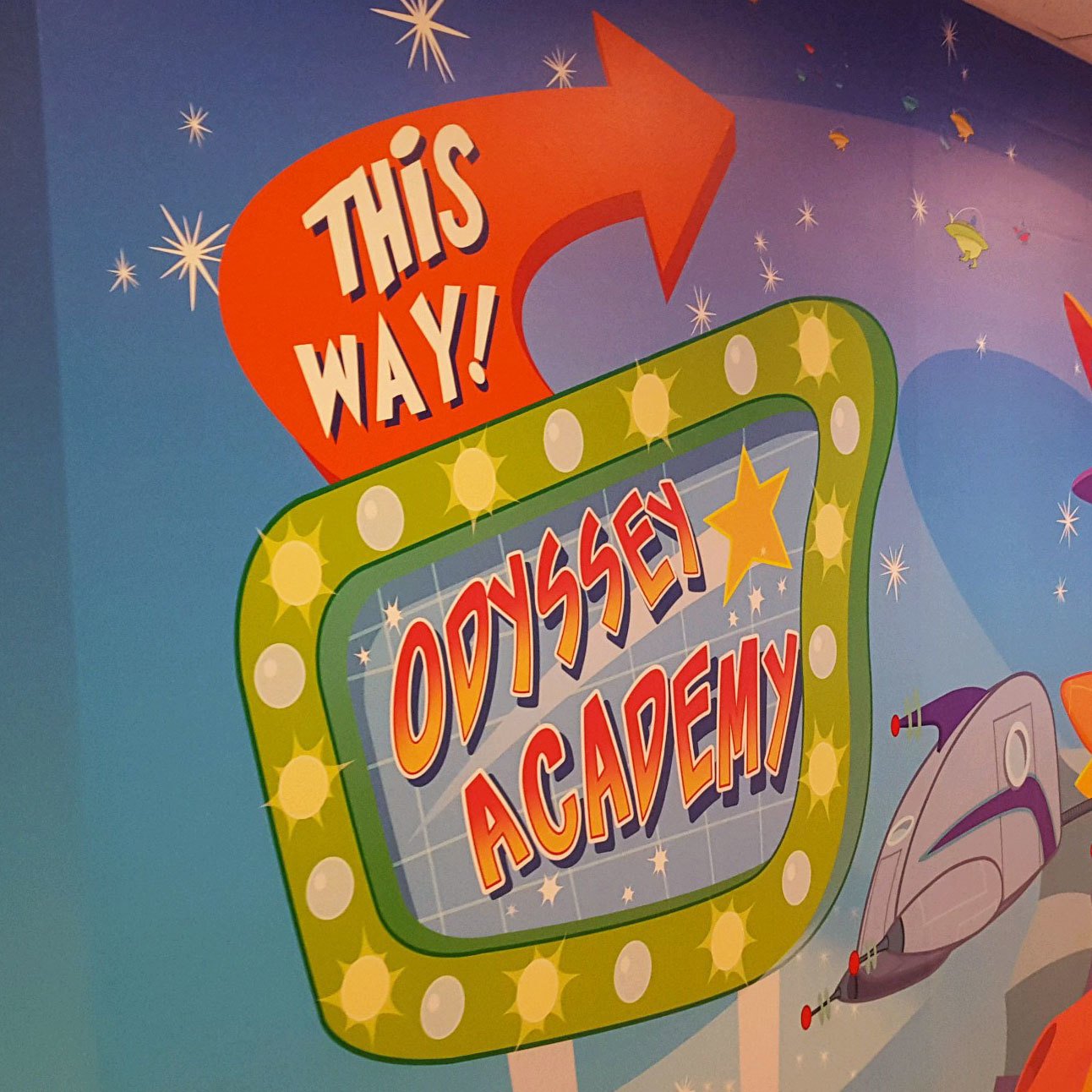 Future World Themed Sign in Wall Covering reading "This Way! → Odyssey Academy" at London Bridge Church
