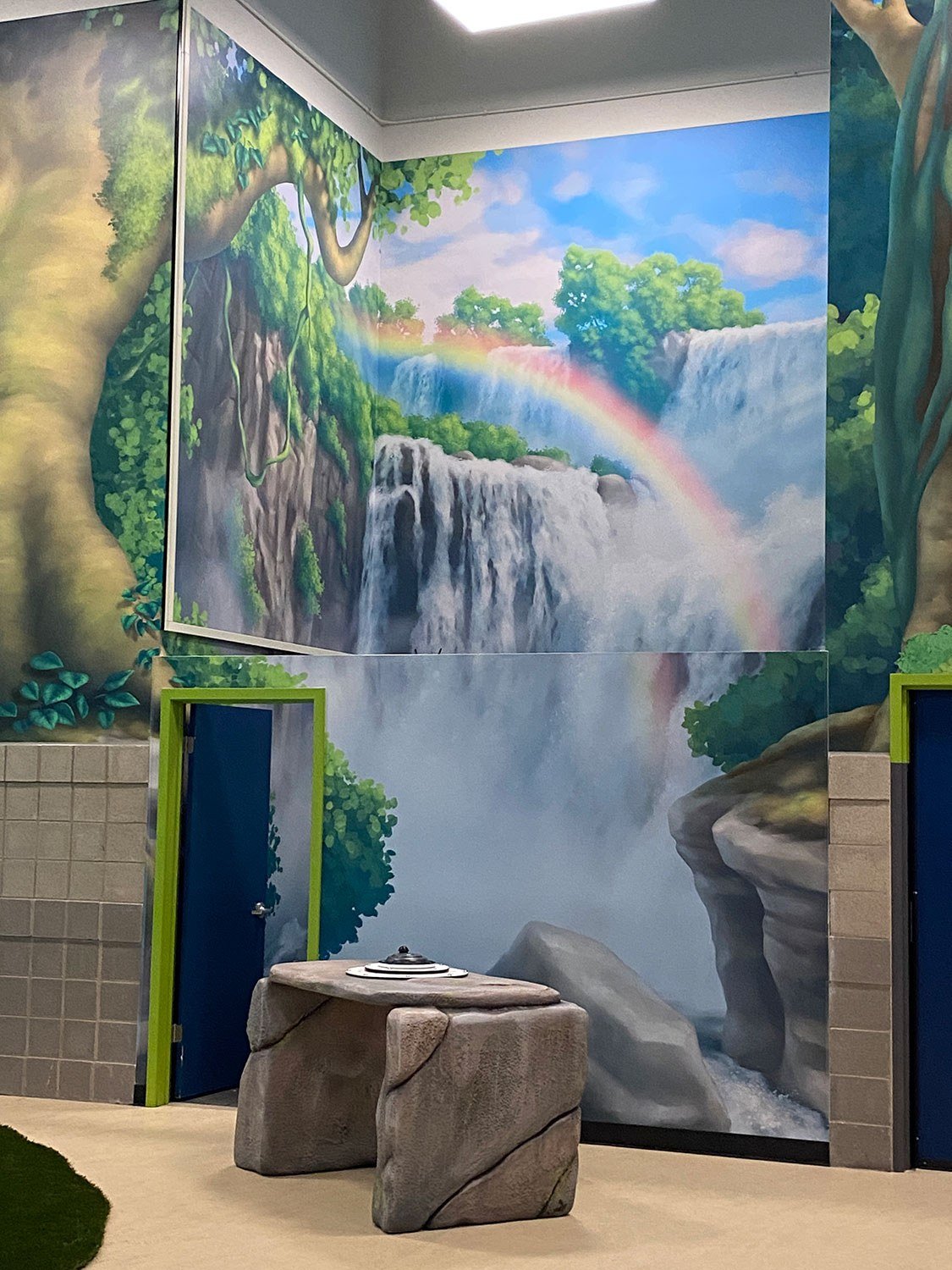 3d Sculpted stone desk and jungle murals at West Chicago Park District Treetop Escape themed environment