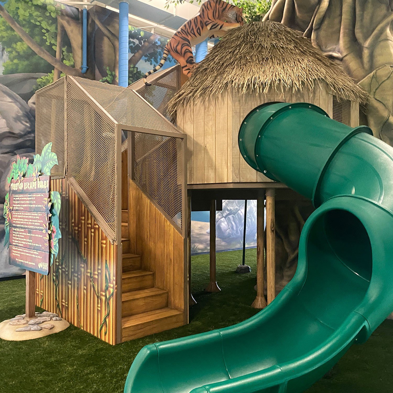 Image of stairs, treehouse and giant green slide