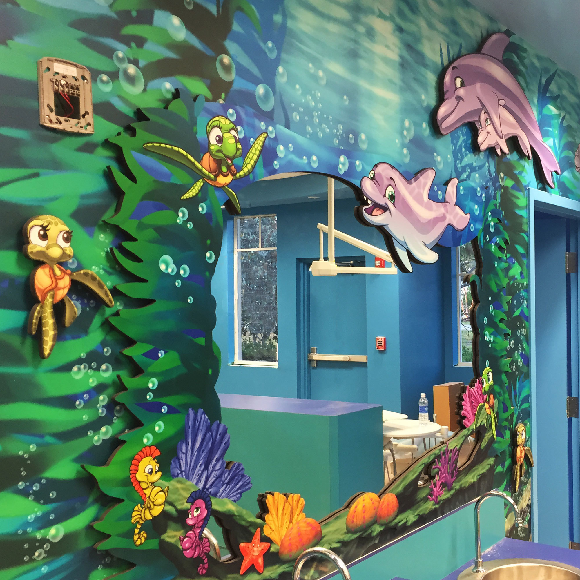 Framed mirror 2D cutout of sea plants and marine life in an Undersea Themed space at Gulfshore Pediatric Dentistry