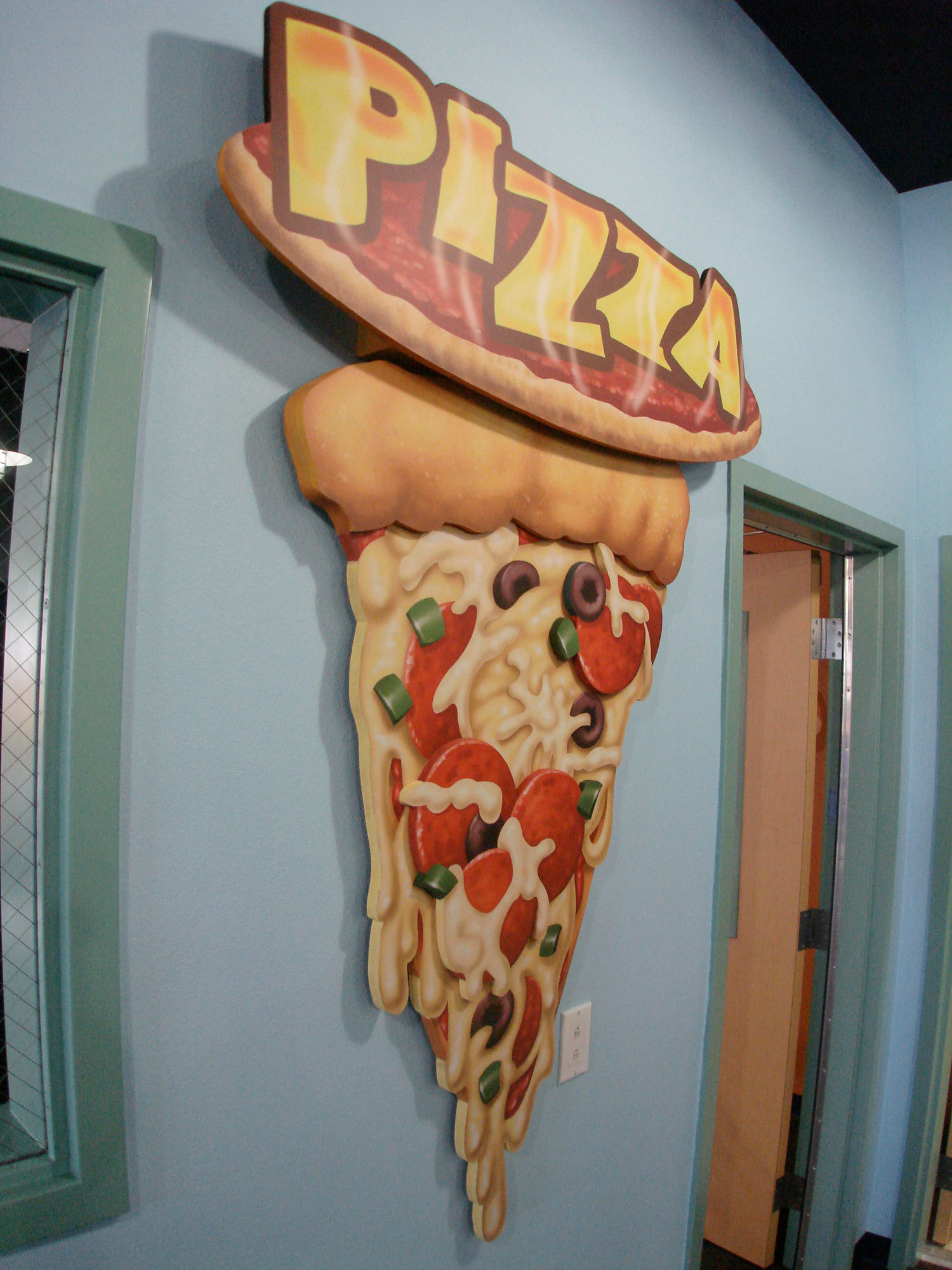 Large 2D Cutout sign of pizza slice and word "Pizza" at Foursquare Church