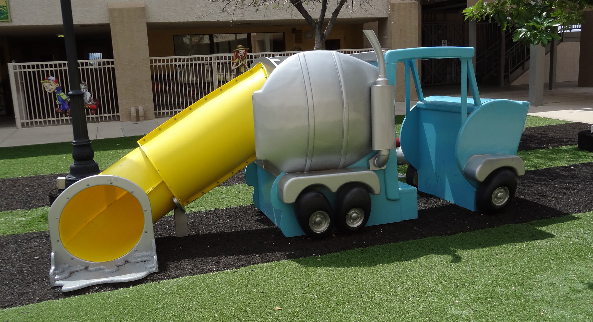 Cement truck Themed Play Feature with yellow slide in Big City Themed outdoor Play Area at Casas Church