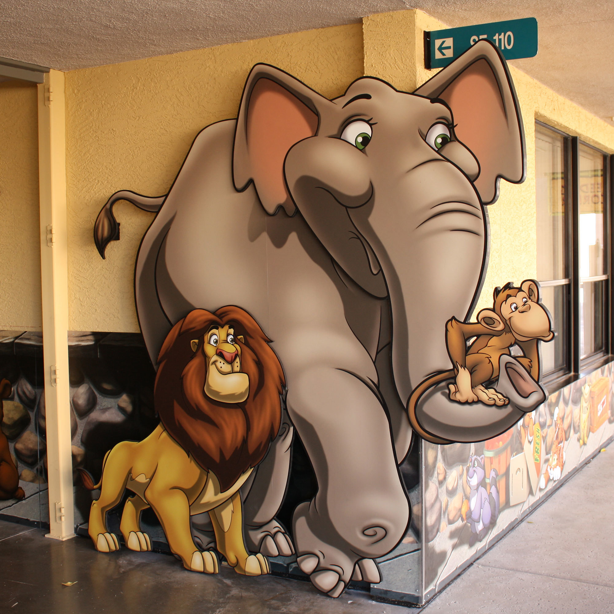 2D cutouts of lion, elephant and monkey in a Zoo & Park themed space at Casas Church