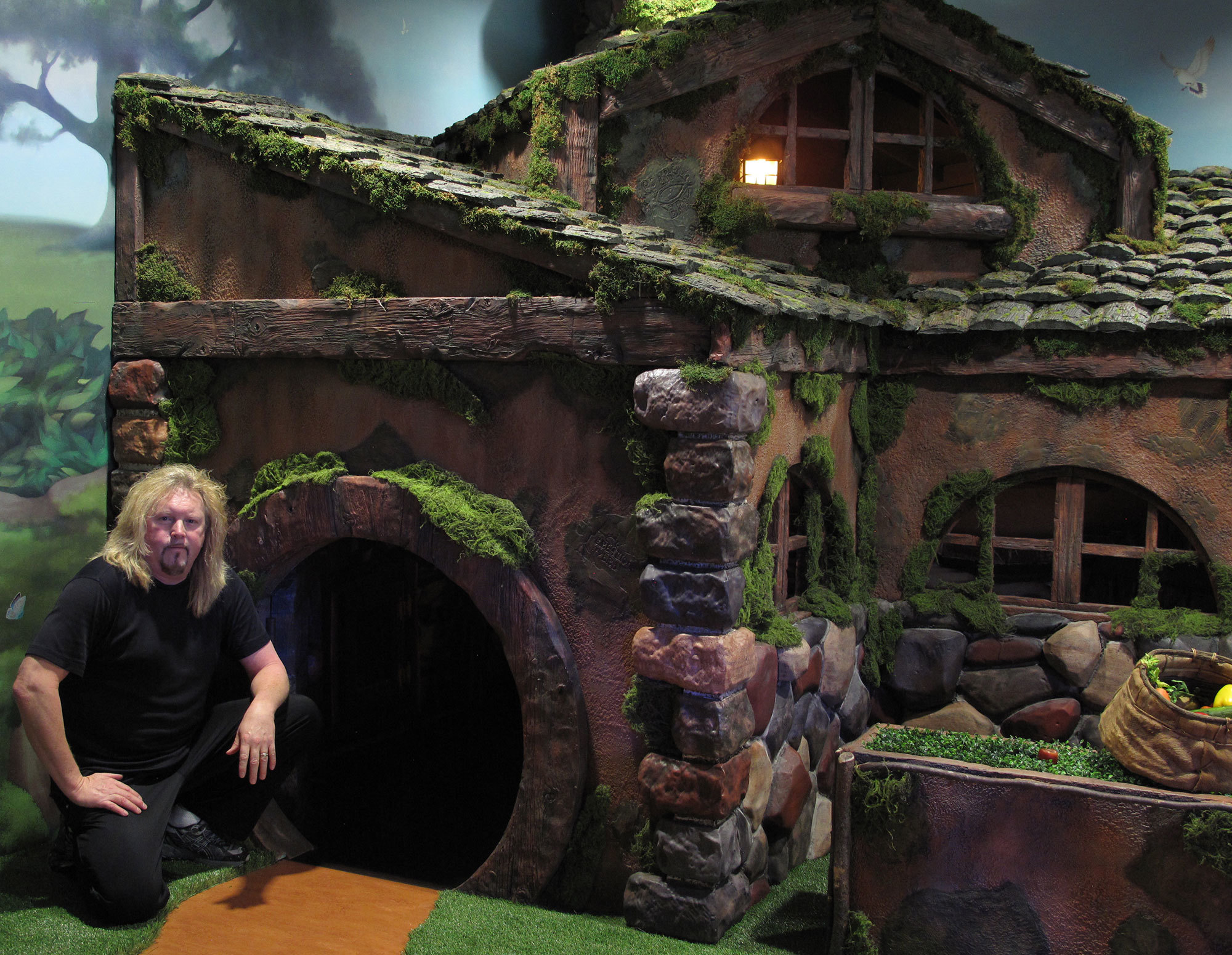 Bruce Barry in front of a Life Sized Hobbit House in a Fantasy Forest and Hobbitville Themed Space at Stonebridge Church