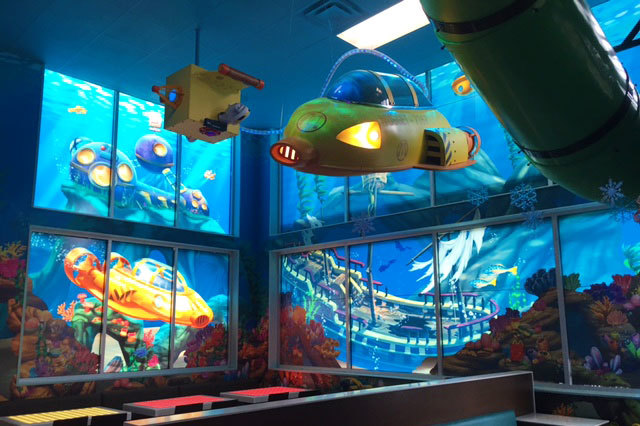 Undersea Themed Environment with hanging yellow sub and window graphics of a sunken ship, an underwater lab and a sub at McDonald's restaurant by Wacky World Studios