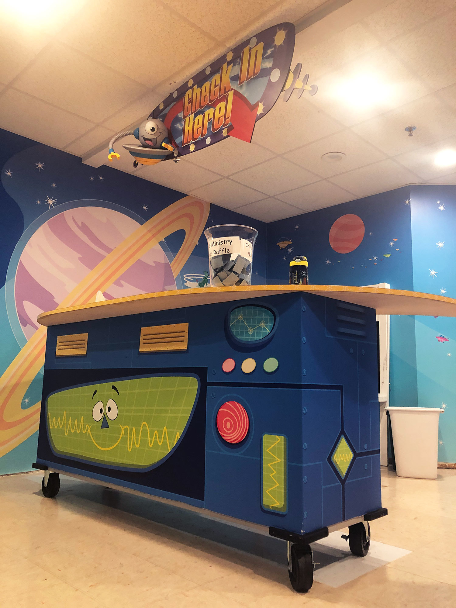 Future World Space Themed Wall Covering and a check in desk wrap featuring wacky graph displays at London Bridge Baptist Church