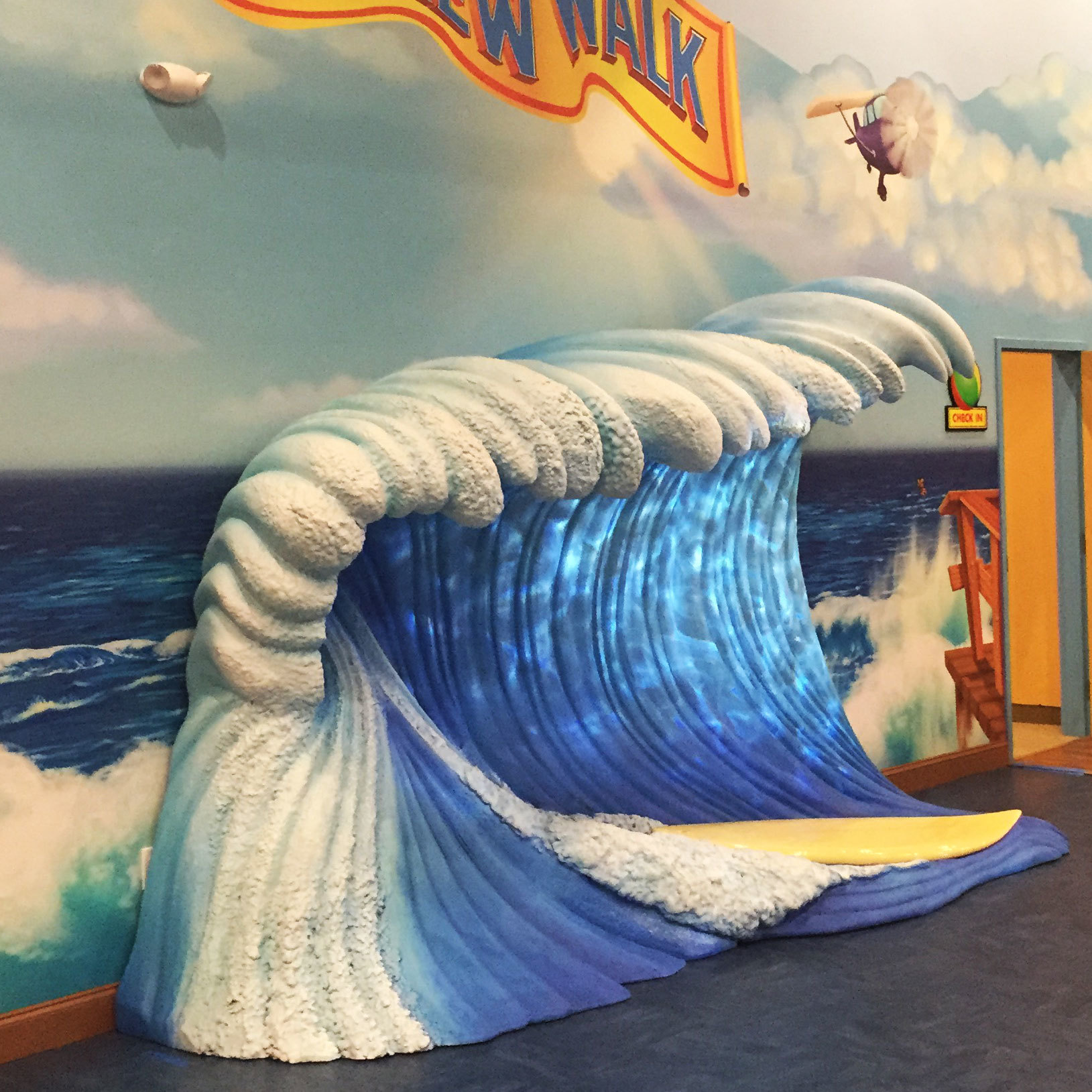 Wave and Surfboard Photo Op Area at Beach and Boardwalk Themed Environment at New Walk Church