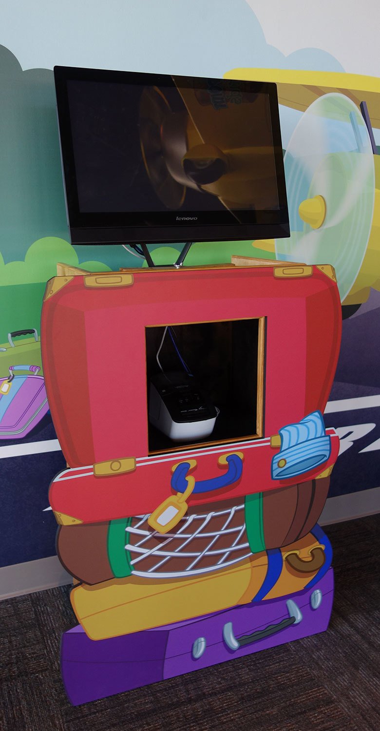 Red, Yellow, Brown and Purple suitcases as an Airport Luggage Themed 2D Cutout Check-In Kiosk