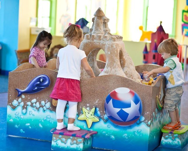 3 Kids playing at a 3D Beach feature with Sandcastle.