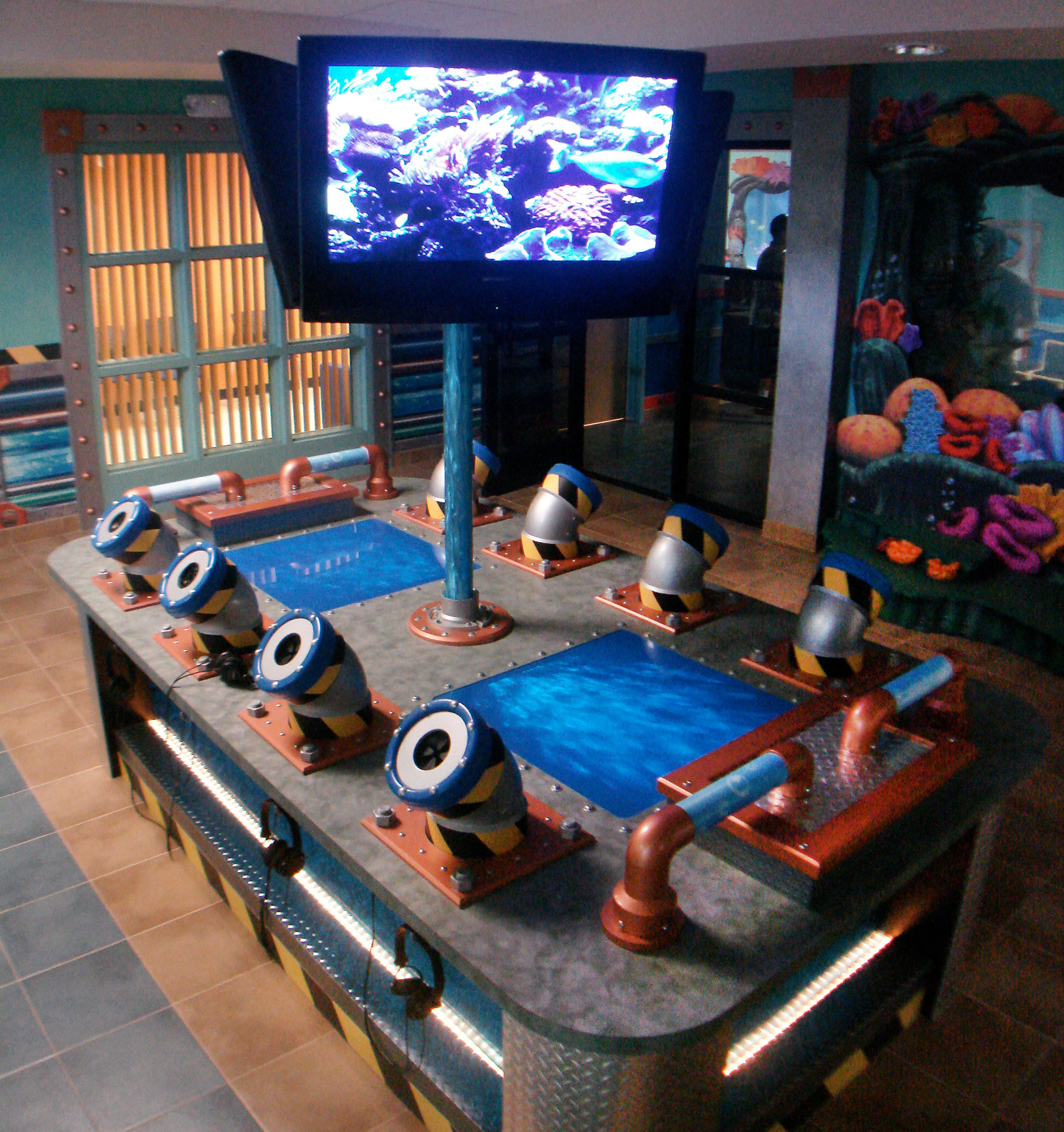 Steel wrapped game station Interactive Play Feature with 3 TV displays and 8 periscope tubes at Foursquare Church