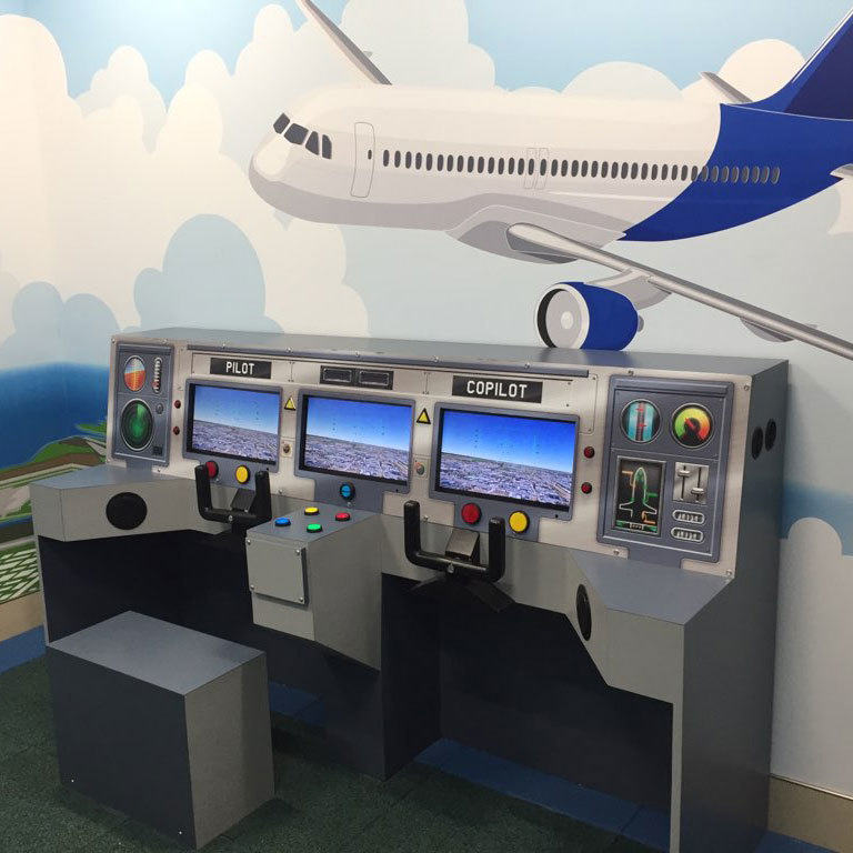 Interactive cockpit with 3 video displays in an Airplane Simulator at Clearwater Airport Play Space