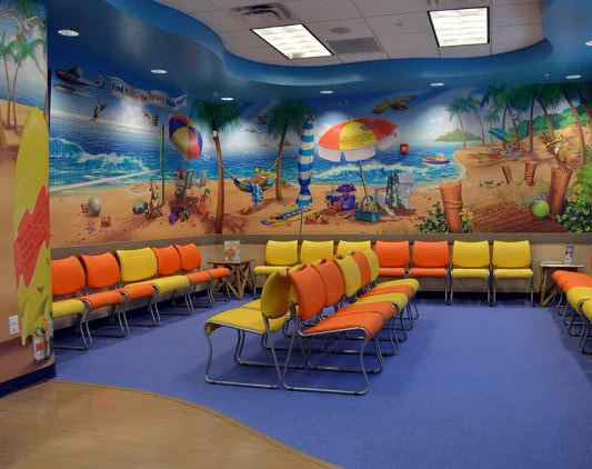 Beach Themed Wall Covering plus yellow and orange seating at Gulf Shore Pediatric Dentistry