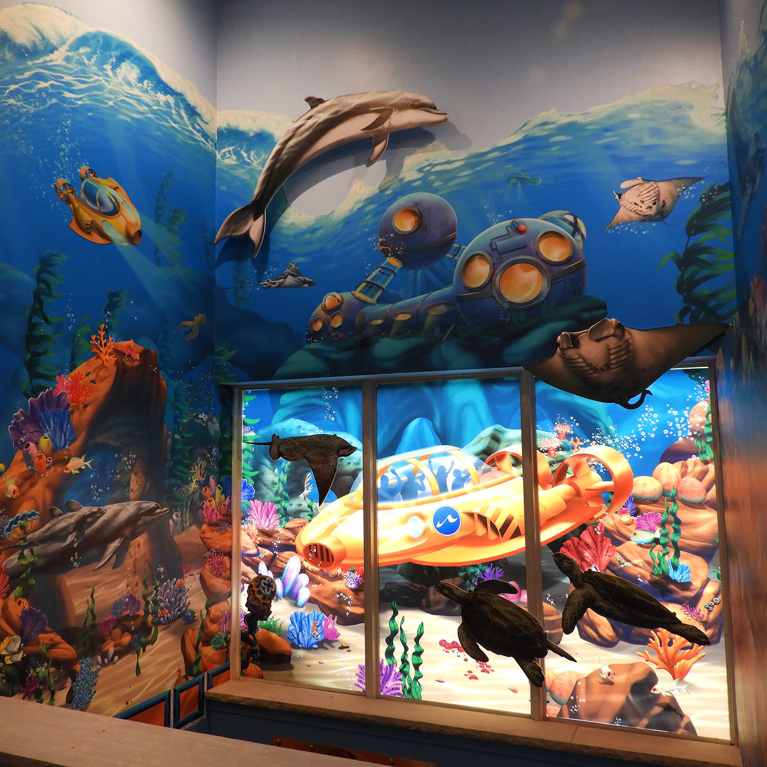 Undersea Themed Window Vinyl of a yellow submarine, Wall Covering of undersea life and coral reef and 2D Cutout of a dolphin at Bridgewater Church from the Inside